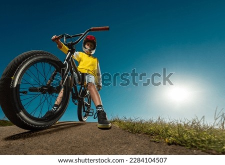 Teenager on a BMX bike in a skate park on a pump track.