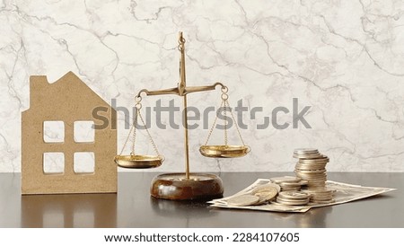Balance, house accessories and money in marble background
