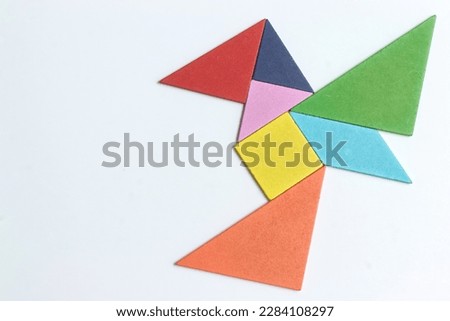color tangram puzzle in flying bird shape on white background	