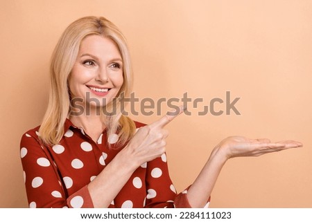 Photo of stunning lady index finger on open palm product empty space corporate advertisement isolated beige color background