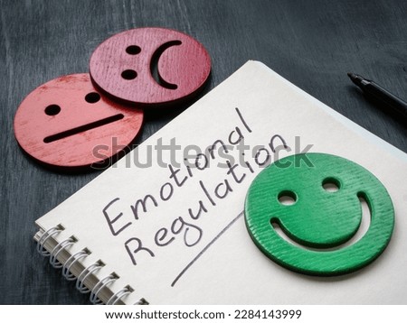 Notepad with inscription emotional regulation and smiley. Royalty-Free Stock Photo #2284143999