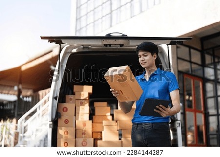 Asian courier with parcel and delivery logistic concept. Delivery man checking address order from cardboard Royalty-Free Stock Photo #2284144287