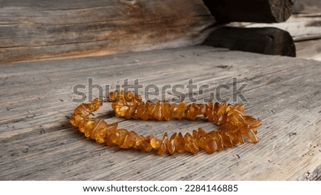 Old Baltic amber necklace on a wood. Amber beads close up. Royalty-Free Stock Photo #2284146885