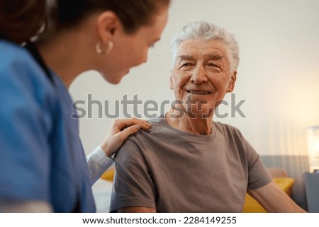 Young nurse checking elderly senior in his home.