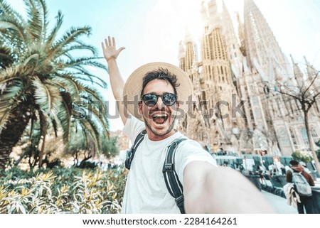 Happy tourist visiting La Sagrada Familia, Barcelona Spain - Smiling man taking a selfie outside on city street - Tourism and vacations concept Royalty-Free Stock Photo #2284164261