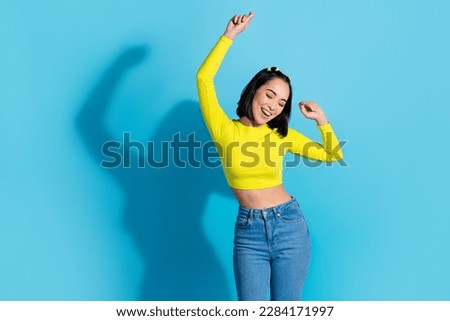 Portrait of cheerful lovely girl have fun good mood dancing partying empty space isolated on blue color background