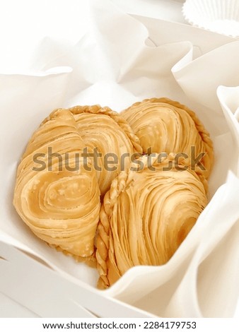 Thai traditional pastry curry puffs on white background.