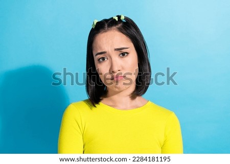 Photo of young unhappy offended depressed girl grimace pouted lips stressed sorrow feel melancholy bullying isolated on blue color background