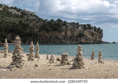 Towers made of beach pebbles as a speciality of this beach, where are many of them. Calm Thracian sea. Livadi beach, Thassos (Tassos), Greece.