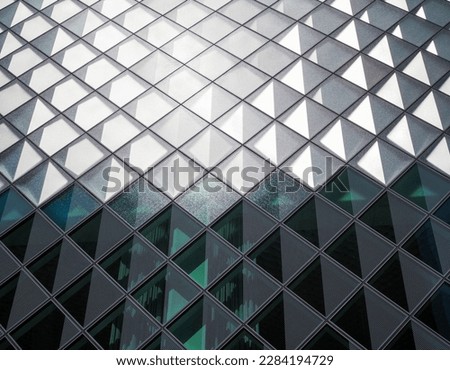 an abstract background a wall with glass in squares and reflections light and dark