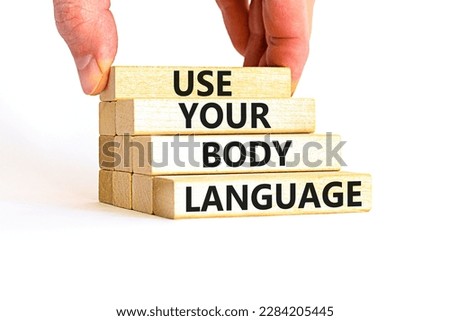 Use your body language symbol. Concept words Use your body language on wooden block. Beautiful white table white background. Motivational business Use your body language concept. Copy space.