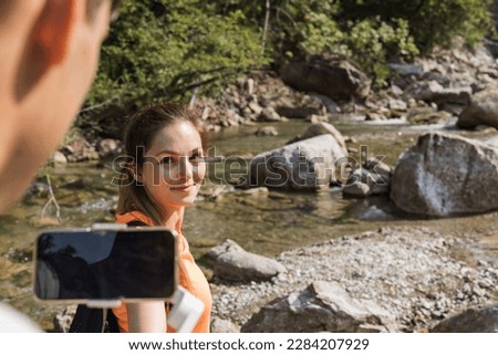 Man holding woman hand while hiking and following her