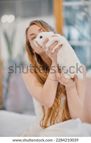 girl holding a white rabbit
