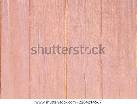 Abstract texture background photo of old dark red brown wooden bright wall detail. Can be used as model. Wood streak vertical fence close up. Use is house wall for background or website wallpaper. 