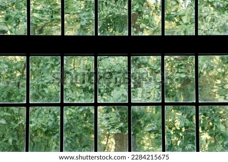 Window Glass Old Imperfect Panes With Transparent Waves Above Tree Garden Royalty-Free Stock Photo #2284215675
