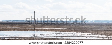 Spilled water on a plowed field in spring
