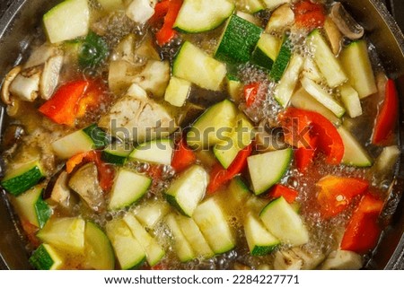Frying pan with vegetables cut for stewing in sauce and spices. Horizontal photo.