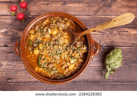 "Arroz brut", a typical Mallorcan dish. Foof from Mallorca. Rice made with seasonal vegetables, mushrooms and game meat. Royalty-Free Stock Photo #2284228383