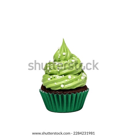 cupcake with green icing and sprinkles isolated on white