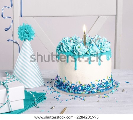 Blue and white Birthday party with cake, gifts and hat over white background.