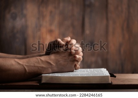 Man hands praying on the bible. Concept religion Royalty-Free Stock Photo #2284246165