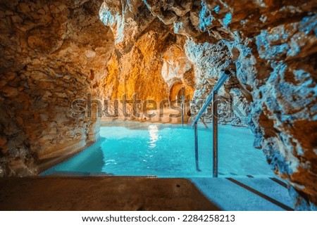Miskolc, Hungary - 3. june. 2022: Tourists enjoy at the cave with thermal water - natural SPA in Hungary at Miskolc Hungary. Rock tube with thermal water