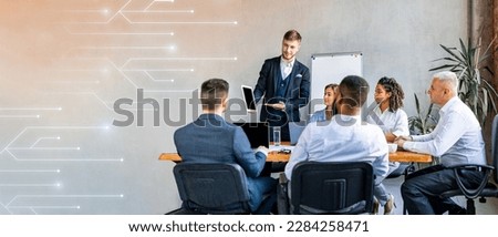 Busy multiethnic young people managers listen boss, talking about work watching presentation on tablet in office interior, free space. Teamwork, professionals and business idea, app for meeting Royalty-Free Stock Photo #2284258471