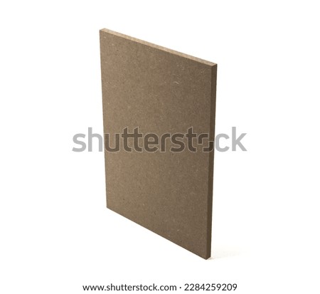 A single board of raw mdf stands upright on a white base. Royalty-Free Stock Photo #2284259209