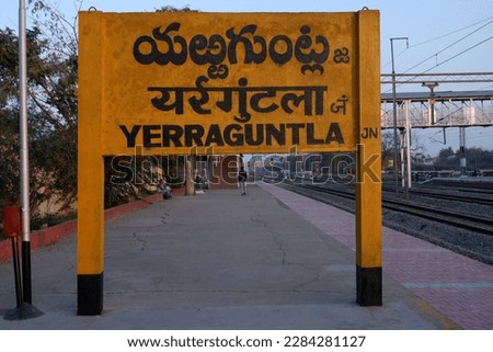 railway station sign with three different languages