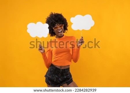 Smart afro american woman with white boards on isolated orange background.