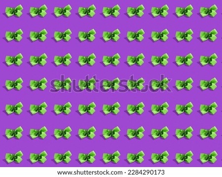 Green ribbons with shamrock on purple color background, Decoration in Irish style. Emerald island theme. Saint Patrick day celebration and national events of Ireland.