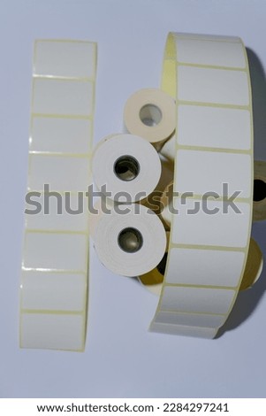Rolls of white labels isolated. Labels for direct thermal or thermal transfer printing. Blank sticky label roll for thermal transfer printing pirce criss.	

