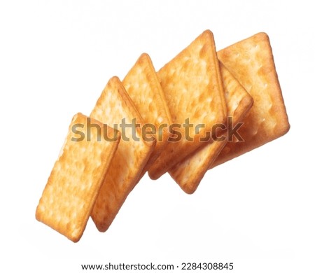 Cracker Butter square fall fly in mid air, golden crispy cracker Butter floating. Cracker Butter complete square throw in air. White background isolated freeze motion high speed shutter Royalty-Free Stock Photo #2284308845