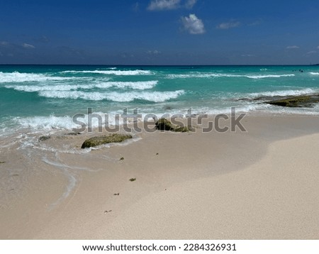 Caribbean Sea washing the sandy coast of Mexico.