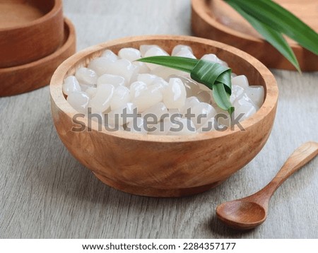 Kolang-kaling or buah tap or kaong (sugar palm fruit) is one of the favourite appetiser and easily found during Ramadhan. served on wooden bowl. selected focus  Royalty-Free Stock Photo #2284357177