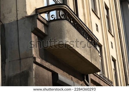 a massive balcony with rounded corners on the street facade