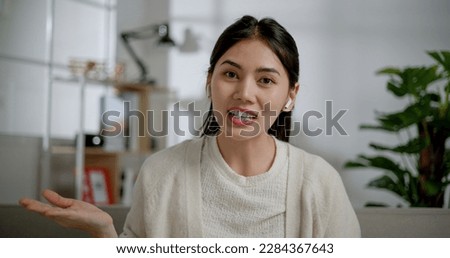 Portrait of Asian young woman during a video chat conference call record vlog teaching on a webinar in the app, webcam view at home. People, technology and lifestyle concepts. Royalty-Free Stock Photo #2284367643