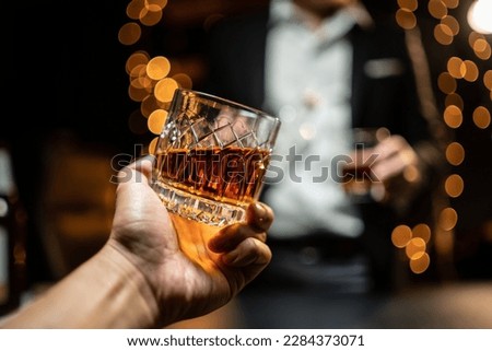 Celebrate whiskey on a friendly party in restaurant Royalty-Free Stock Photo #2284373071