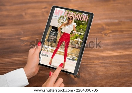Woman reading digital edition of fashion magazine on tablet computer