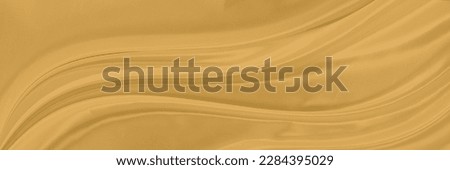 yellow gold satin texture that is white silver fabric luxurious shiny that is abstract silk cloth background with patterns soft waves blur beautiful.
