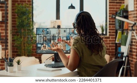 Female employee attending remote videocall meeting on webcam, using computer to talk to people on online teleconference call. Woman chatting with colleagues on videoconference, work from home. Royalty-Free Stock Photo #2284401371