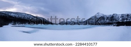 Mountain range around the frozen turquoise lake 'Strandvand' covered with water. Arctic Circle, Nordland, Northern Norway, Norway, Nordic countries, Northern Europe
