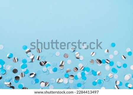 Boy, baby birthday, celebration, fathers day concept with blue confetti on blue background, top view, copy space Royalty-Free Stock Photo #2284413497