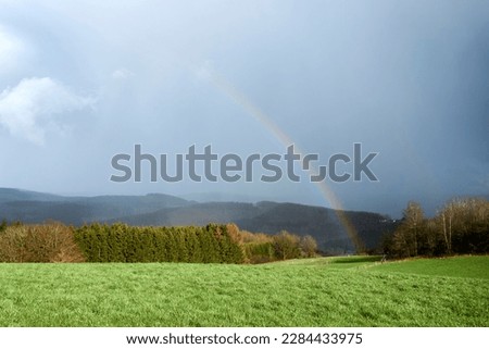 photographed a colorful rainbow in spring in april in germany.