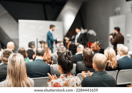 Business team leader receiving award prize at best business project competition event. Business and entrepreneurship award ceremony theme. Focus on unrecognizable people in audience Royalty-Free Stock Photo #2284441659