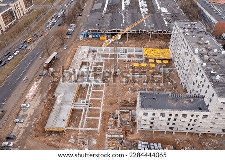 Drone photography of apartment construction site during spring morning. High angle view