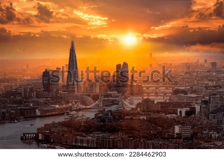 A beautiful sunset behind the London skyline with Tower Bridge, River Thames and the corporate skyscrapers