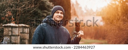 Man photographer with modern mirrorless camera outdoor. Photographer website banner concept.