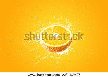 Creative layout made from Fresh Sliced oranges and Orange fruit and water Splashing on a orange background. Royalty-Free Stock Photo #2284469627