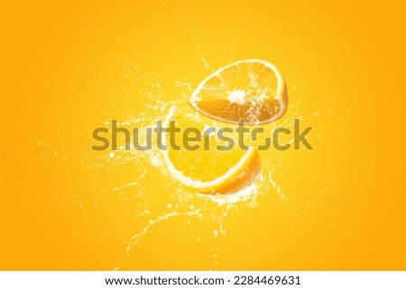Creative layout made from Fresh Sliced oranges and Orange fruit and water Splashing on a orange background. Royalty-Free Stock Photo #2284469631